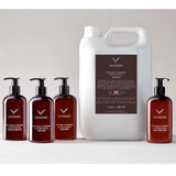 Group of 4 300ml amber bottles and a 5 litre refill of Odyssey toiletries