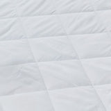 Close-up image showcasing the detailed quilted stitching pattern on the white pillow protector, highlighting its plush and durable design.