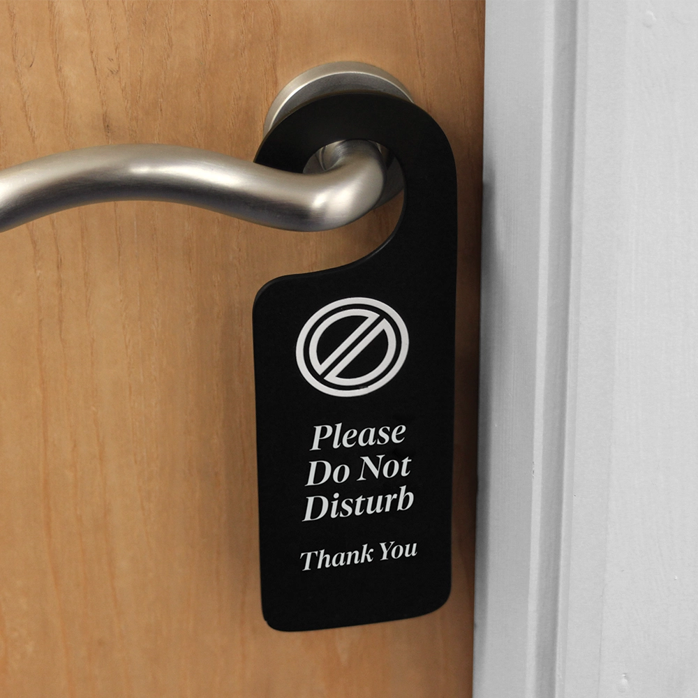 Front view of a wooden door hanger with a blackboard-effect finish, displaying the message 'Please Do Not Disturb' in white lettering.