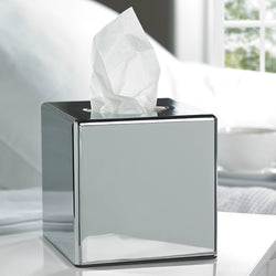 Chrome cube tissue box cover with tissues being dispensed from the top