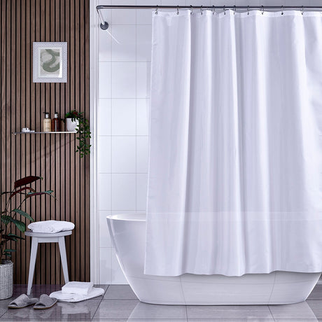 White Shower curtain hanging on a rail over a bath