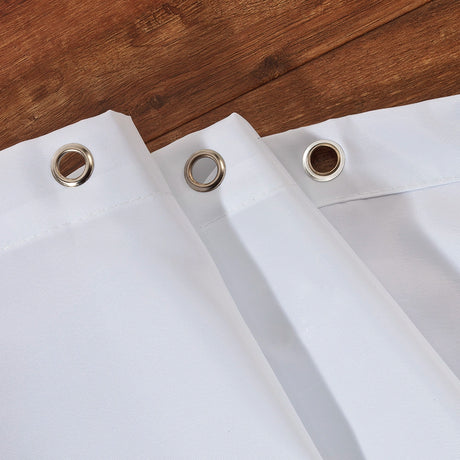 Close up of metal eyelets on the top of the white shower curtain