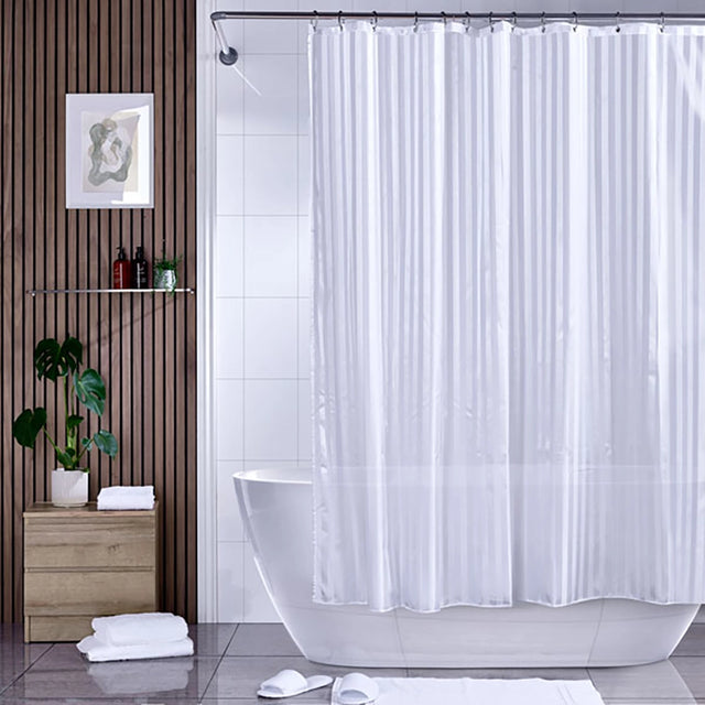 Satin stripe shower curtain hanging from a metal rail over a bath